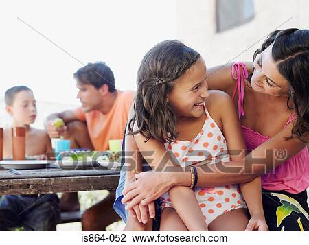 Stock Image - Mother and daughter at meal outdoors. Fotosearch