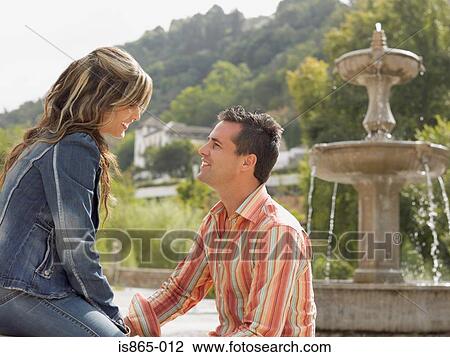 Stock Image - Couple by fountain. Fotosearch