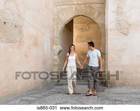 Couple hand in hand by arch View Large Photo Image Stock Image - Couple hand in hand by arch. Fotosearch