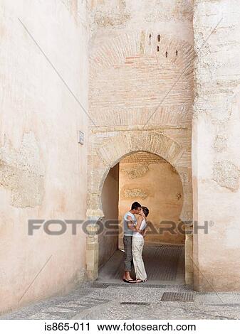 Couple kissing under arch View Large Photo Image Stock Image - Couple kissing under arch. Fotosearch