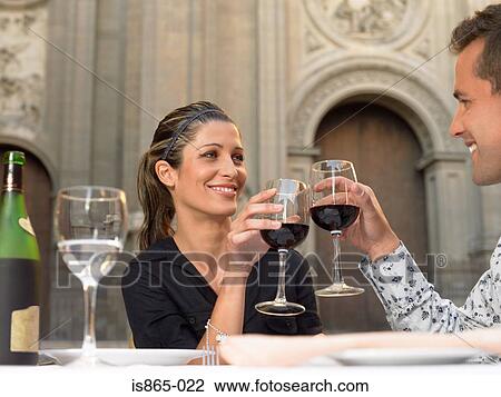 Stock Image - Couple toasting with wine. Fotosearch