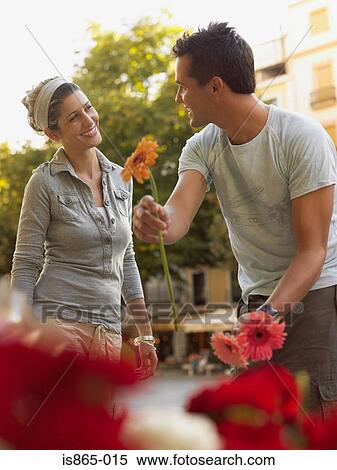 Man and woman with flowers View Large Photo Image Stock Photography - Man and woman with flowers. Fotosearch