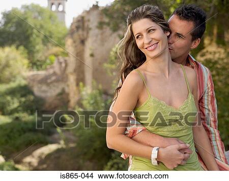 Picture - Man kissing woman on neck. Fotosearch