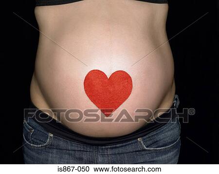Stock Image - A heart on a pregnant womans stomach. Fotosearch