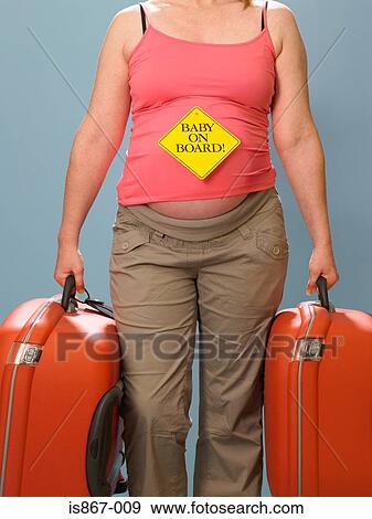 Pregnant woman carrying suitcases View Large Photo Image Stock Photo - Pregnant woman carrying suitcases. Fotosearch