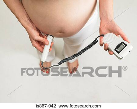 Pregnant woman checking babys pulse View Large Photo Image Stock Image - Pregnant woman checking babys pulse. Fotosearch