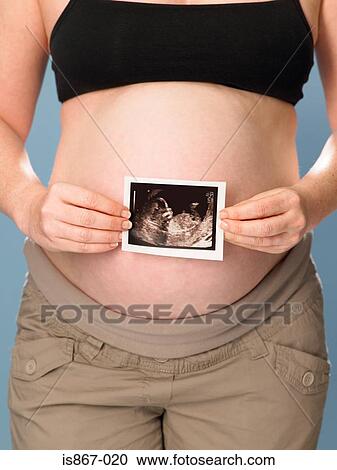 Pregnant woman holding scan View Large Photo Image Stock Image - Pregnant woman holding scan. Fotosearch