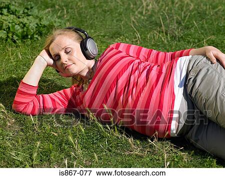Pregnant woman listening to music View Large Photo Image Stock Photo - Pregnant woman listening to music. Fotosearch
