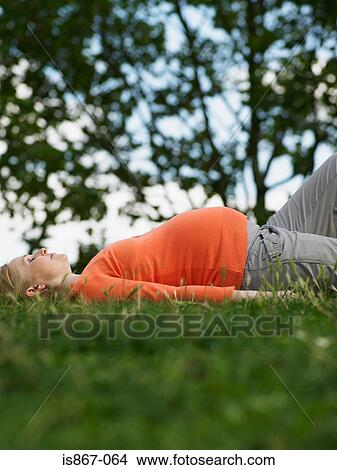 Picture - Pregnant woman lying down. Fotosearch