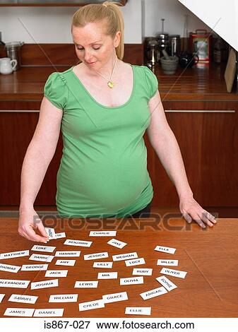 Pregnant woman picking names View Large Photo Image Stock Photo - Pregnant woman picking names. Fotosearch