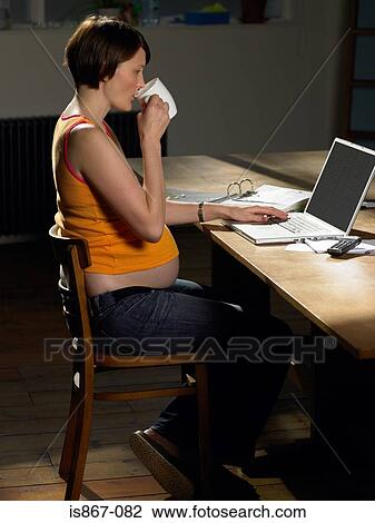 Pregnant woman typing View Large Photo Image Stock Image - Pregnant woman typing. Fotosearch