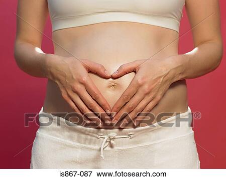 Pregnant woman with heart shape on stomach View Large Photo Image Stock Photo - Pregnant woman with heart shape on stomach. Fotosearch