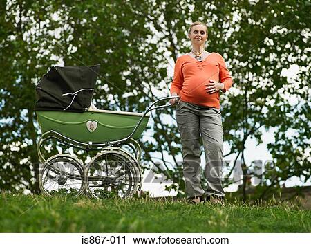 Pregnant woman with pram View Large Photo Image Stock Image - Pregnant woman with pram. Fotosearch
