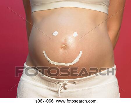 Pregnant woman with smiley face on stomach View Large Photo Image Stock Photograph - Pregnant woman with smiley face on stomach. Fotosearch