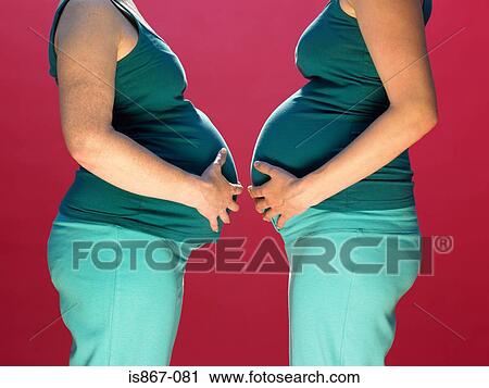 Pregnant women facing each other View Large Photo Image Stock Image - Pregnant women facing each other. Fotosearch
