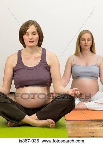 Pregnant women practising yoga View Large Photo Image Stock Photograph - Pregnant women practising yoga. Fotosearch