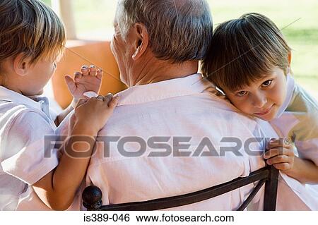 Stock Photograph - Boys hugging grandfather. Fotosearch