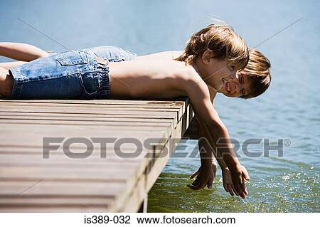 Boys lying on decking View Large Photo Image Stock Image - Boys lying on decking. Fotosearch