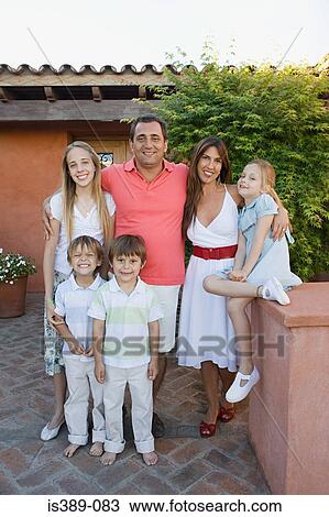 Family standing outside a house View Large Photo Image Stock Image - Family standing outside a house. Fotosearch