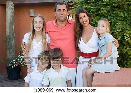Family standing outside a house View Large Photo Image Stock Photo - Family standing outside a house. Fotosearch