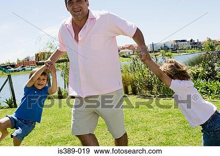 Father playing with two sons View Large Photo Image Stock Photo - Father playing with two sons. Fotosearch