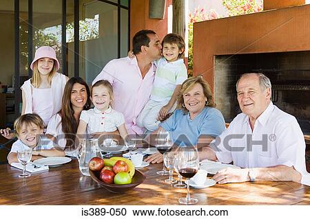 Three generation family at dining table View Large Photo Image Stock Image - Three generation family at dining table. Fotosearch
