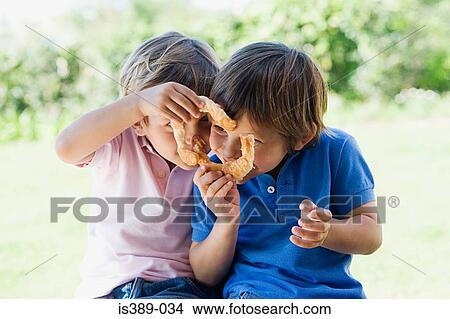 Two boys sharing a cake View Large Photo Image Picture - Two boys sharing a cake. Fotosearch