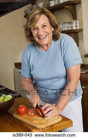 Stock Image - Woman preparing a salad. Fotosearch