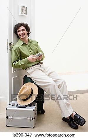 Stock Photo - Man using handheld computer. Fotosearch
