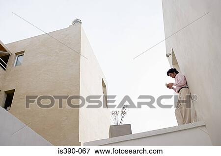 Stock Photo - Man using handheld computer. Fotosearch