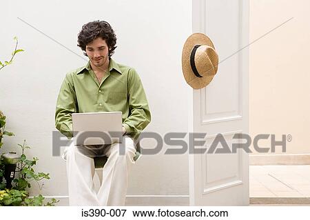Stock Photo - Man working on laptop. Fotosearch