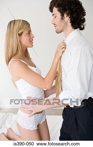 Stock Image - Woman adjusting mans tie. Fotosearch