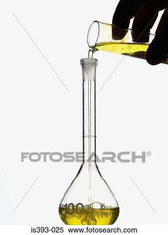 Liquid being poured into glass flask View Large Photo Image Stock Photography - Liquid being poured into glass flask. Fotosearch