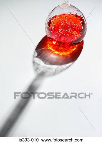 Stock Image - Red liquid in a glass flask. Fotosearch