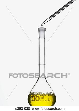 Stock Image - Volumetric flask and pipette. Fotosearch