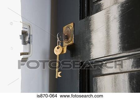 Picture - Key in open door. Fotosearch