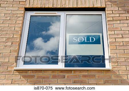 Stock Photography - Sold sign in window of new house. Fotosearch