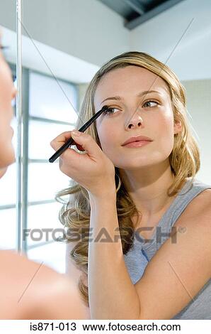 Woman applying eyeshadow View Large Photo Image Stock Image - Woman applying eyeshadow. Fotosearch