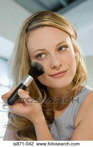 Woman applying face powder View Large Photo Image Stock Image - Woman applying face powder. Fotosearch