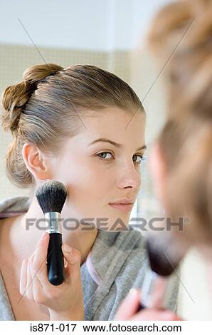 Stock Photo - Woman applying face powder. Fotosearch