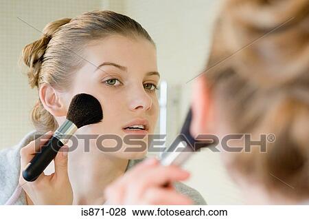 Stock Photo - Woman applying face powder. Fotosearch