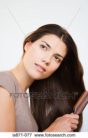 Stock Photo - Woman brushing hair. Fotosearch