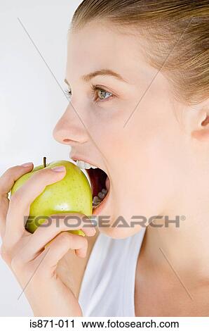 Woman eating apple View Large Photo Image Stock Image - Woman eating apple. Fotosearch