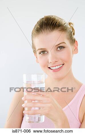 Woman holding glass of water View Large Photo Image Stock Photograph - Woman holding glass of water. Fotosearch