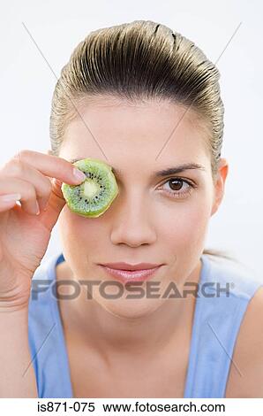 Woman holding kiwi fruit View Large Photo Image Stock Photography - Woman holding kiwi fruit. Fotosearch