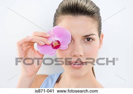 Woman holding orchid View Large Photo Image Stock Image - Woman holding orchid. Fotosearch
