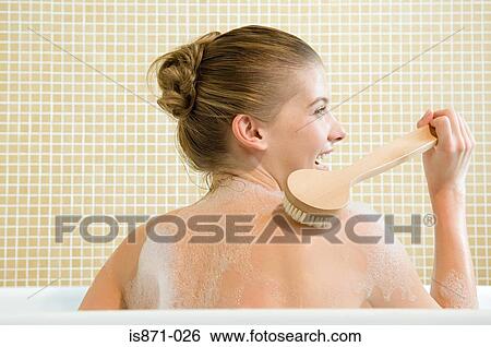 Woman scrubbing back View Large Photo Image Stock Photograph - Woman scrubbing back. Fotosearch