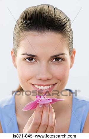 Woman smelling orchid View Large Photo Image Stock Photography - Woman smelling orchid. Fotosearch