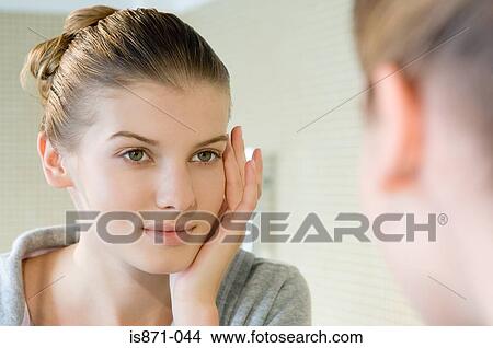 Picture - Woman touching face. Fotosearch