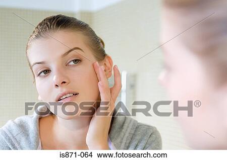 Woman touching face View Large Photo Image Picture - Woman touching face. Fotosearch